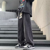 Japanese-style Drawstring Elastic-waist Jeans For Men worn with a stylish oversized shirt and sporty shoes.