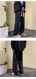 Japanese-style Drawstring Elastic-waist Jeans For Men shown from side view with relaxed fit and casual sneakers.