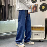 Japanese-style Drawstring Elastic-waist Jeans For Men showcased in a trendy outfit with relaxed fit and casual vibe.